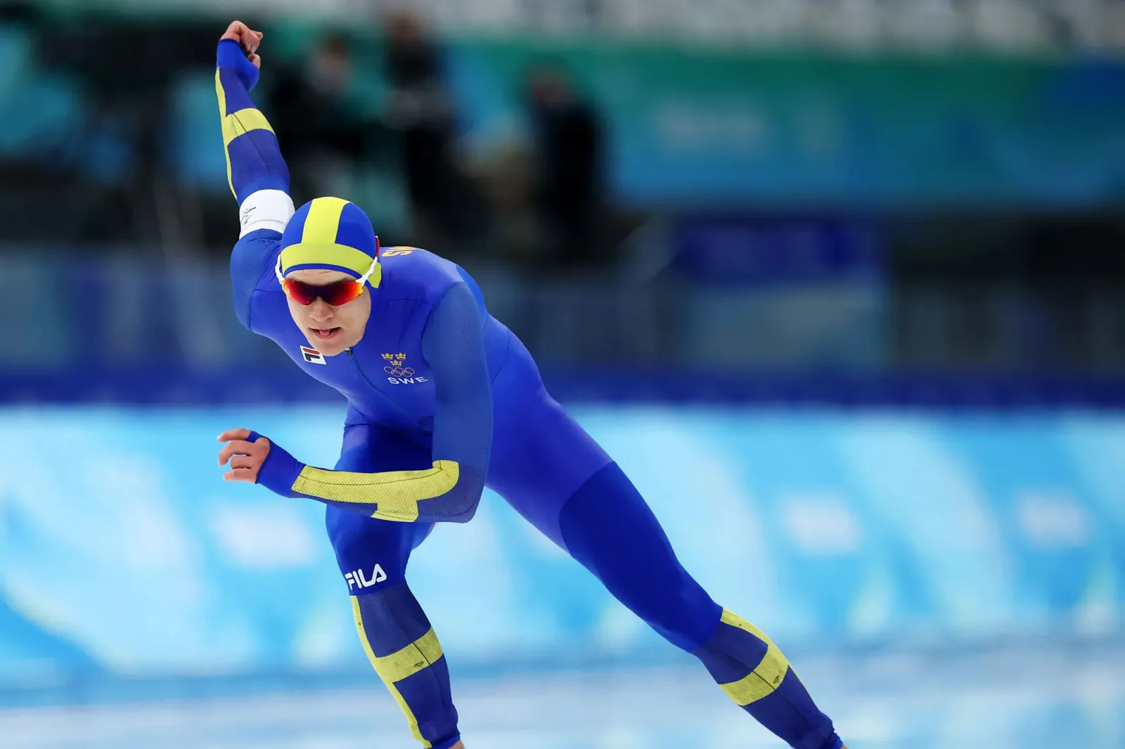 Nils van der Poel racing in Sweden’s blue and yellow skinsuit at the 2022 Beijing Olympics