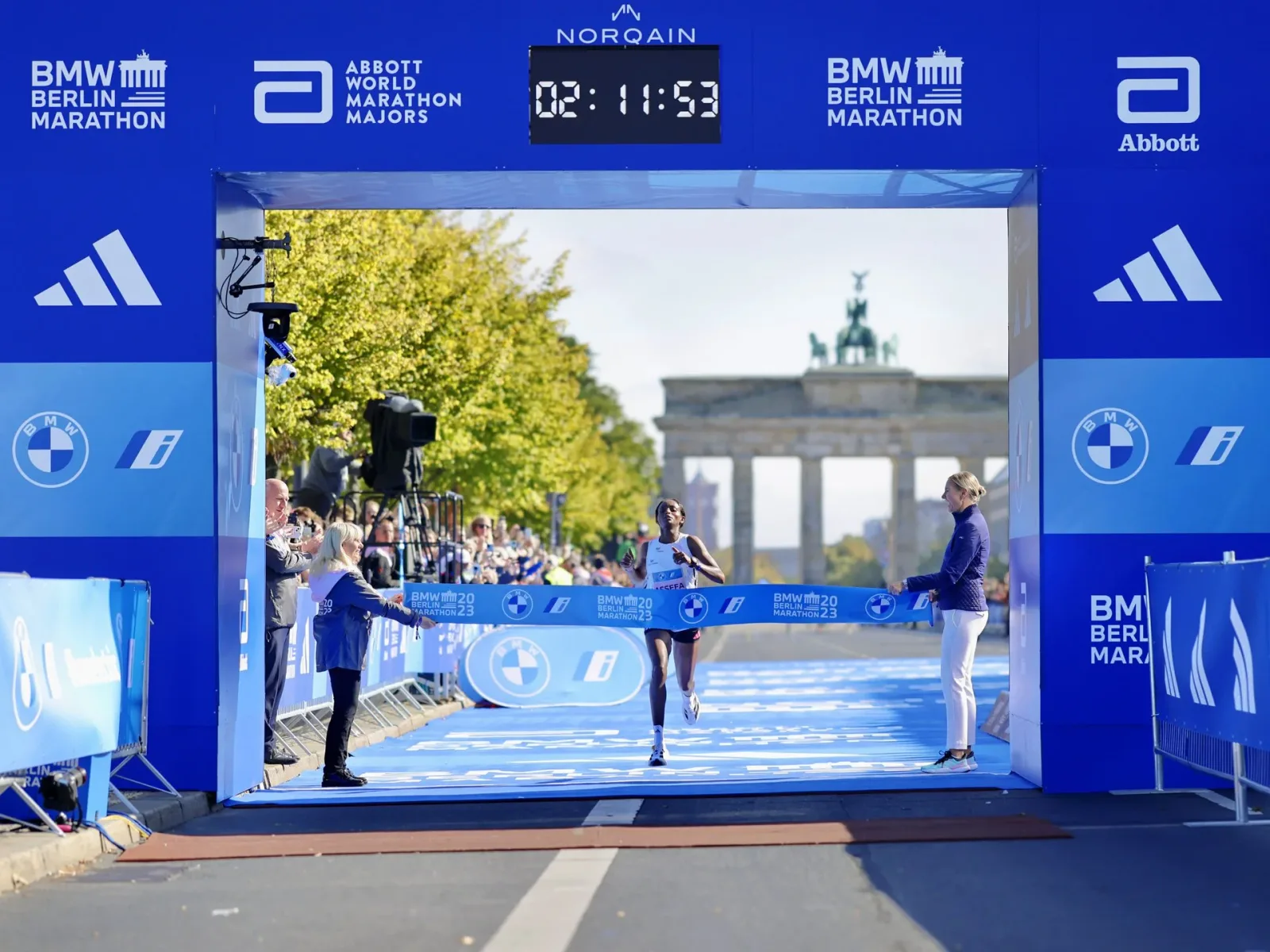 Tigst Assefa kneeling at the Berlin Marathon finish line