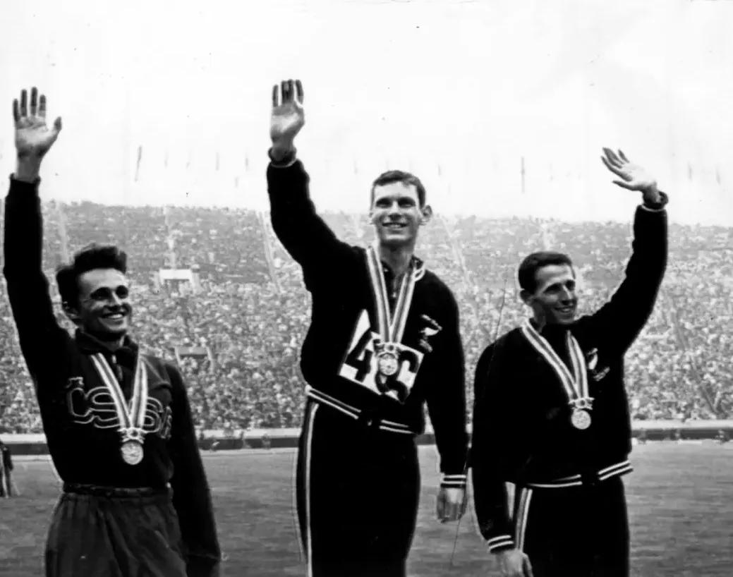 Peter Snell and John Davies celebrating their medals at the 1964 Tokyo Olympics